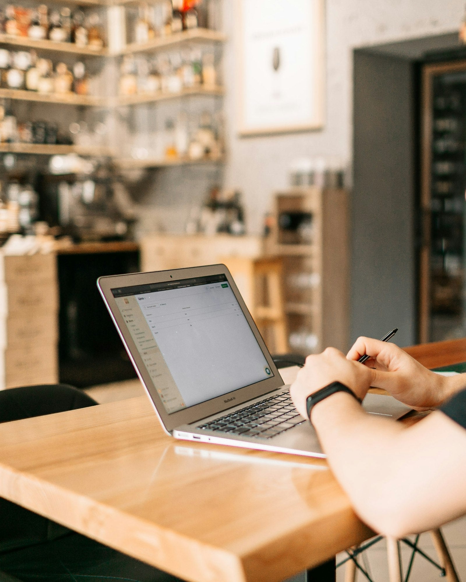 Restaurant manager working on a laptop at a wooden table