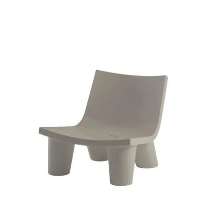 Fermob Low Lita lounge chair with a curved design and colorful modern outdoor furniture for relaxing in style.