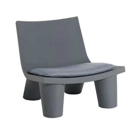 Fermob Low Lita Lounge Chair with curved metal frame and colorful fabric seating for outdoor relaxation.