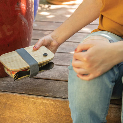  showcasing a clear container with a natural bamboo top for eco-friendly storage.