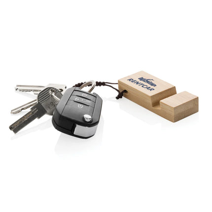XD Collection Standkey bamboo keychain phone stand attached to a smartphone for hands-free viewing.