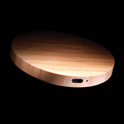  sleek bamboo design with charging pad and cable visible.