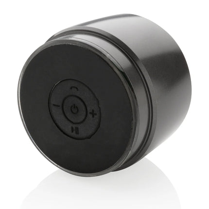 Swiss Peak 5W wireless bass speaker showing a sleek black design with control buttons on the top.