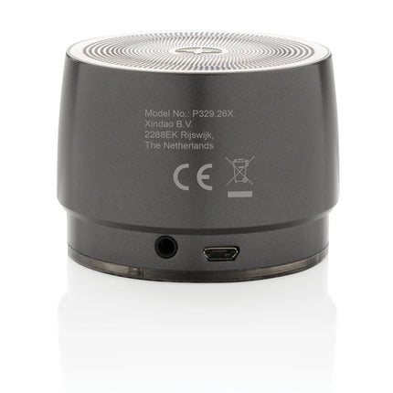  showcasing its compact audio device on a modern surface.