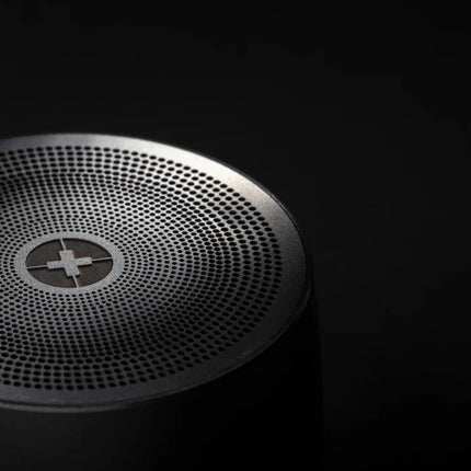 Swiss Peak 5W wireless bass speaker showcasing a sleek black design with control buttons and a compact portable build.