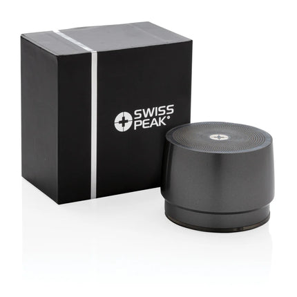 Swiss Peak 5W wireless bass speaker showing a compact black audio device with control buttons and connection ports.