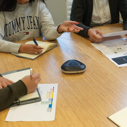  compact audio device with microphone and control buttons for clear group conversations.