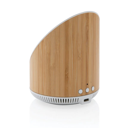 Ovate bamboo XD Xclusive 5W Bluetooth speaker with integrated 15W wireless charger on a sleek wooden surface.