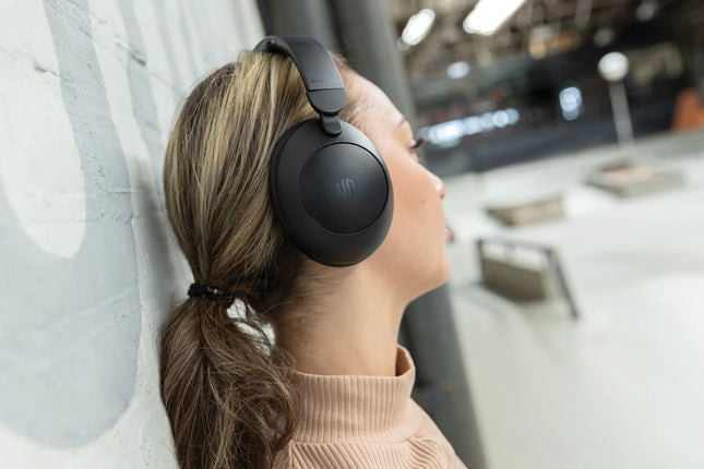 Urban Vitamin Cupertino RCS plastic ANC headphones shown in black with cushioned ear cups and adjustable headband.