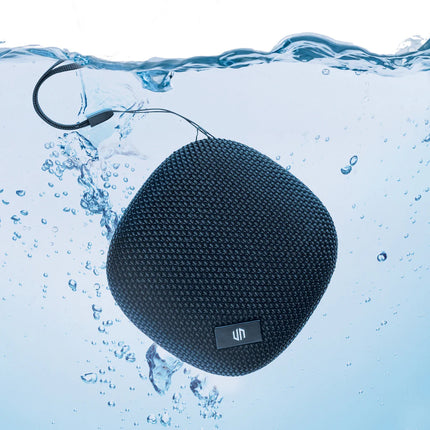 Urban Vitamin IPX7 waterproof 5W portable speaker shown outdoors with a rugged design and water-resistant features.