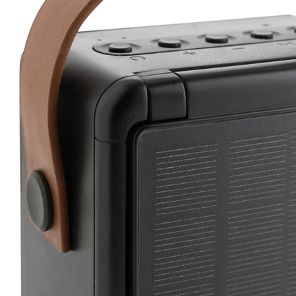  12W portable audio device with solar panel for eco-friendly listening.