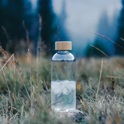  eco-friendly drinkware featuring a clear bottle and natural bamboo cap.