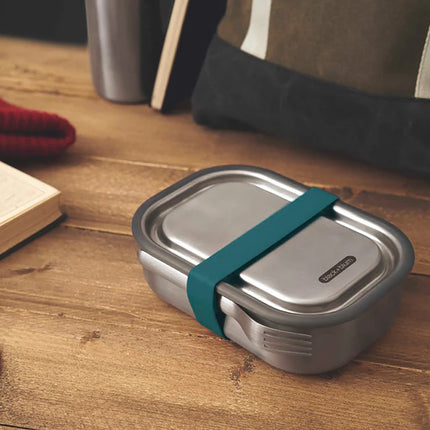 Large stainless steel lunch box by Black + Blum with multiple compartments for home and living use.