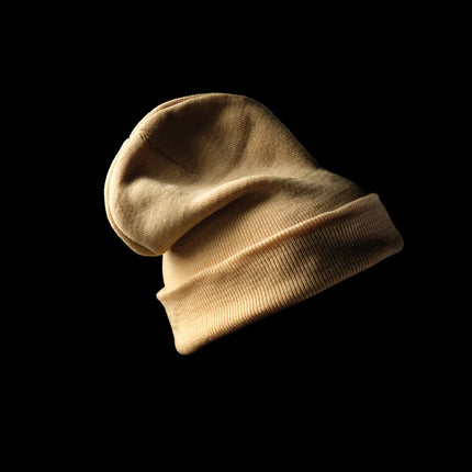  showcasing its soft knit texture and stylish headwear design.