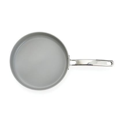 Vinga Alte RCS 25cm recycled aluminum fry pan with non-stick surface for home cooking, shown on a kitchen countertop.