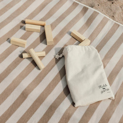 Vinga Artisanal Kubb Mini Set from the Heritage Collection with fine walnut outdoor game pieces on a natural background.