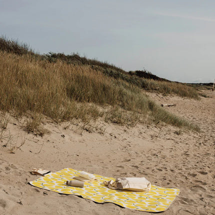 Vinga Arw GRS Collection outdoor picnic blanket with recycled PET fleece, PEVA backing, and cotton canvas flap, laid on grass.