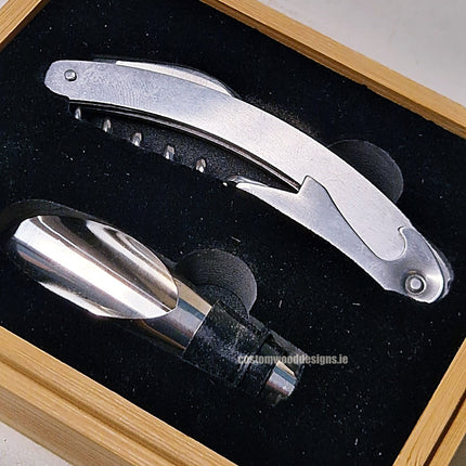 Two-piece wine set in a bamboo box by Custom Wood Designs, displayed in a natural wood finish, with wine accessories inside.
