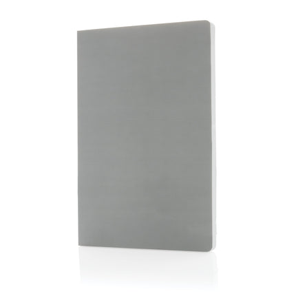 Pack of 25 navy A5 softcover notebooks made from stone paper, by Custom Wood Designs, shown stacked with open pages.