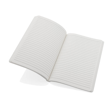 Pack of 25 navy A5 softcover notebooks with stone paper from Custom Wood Designs, showing the notebooks stacked and open.