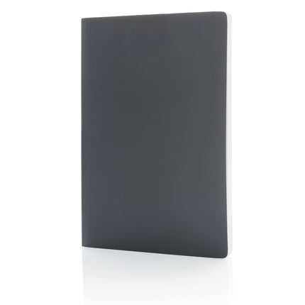 Pack of 25 navy A5 softcover notebooks made of stone paper by Custom Wood Designs, featuring durable covers and eco-friendly pages.