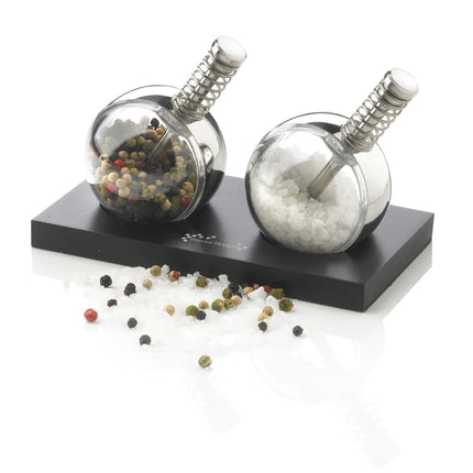 XD Design Planet pepper and salt set with round ceramic shakers and matching stand for stylish kitchen seasoning.