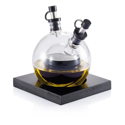XD Design Orbit oil and vinegar set with glass bottles and black caps for kitchen storage and condiment serving.