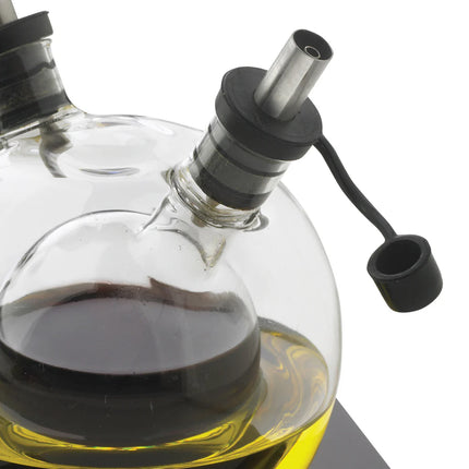 XD Design Orbit oil and vinegar set with clear glass bottles and black pour tops for kitchen storage and seasoning.