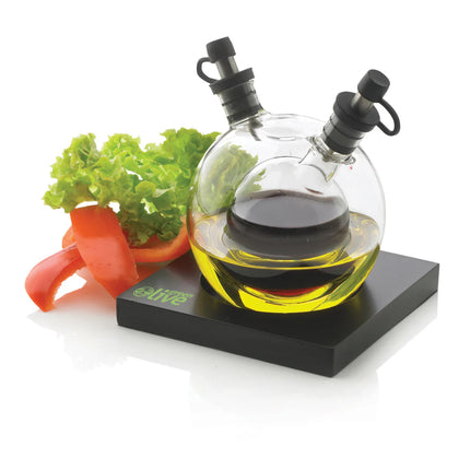 XD Design Orbit oil and vinegar set with clear glass bottles and black caps for kitchen storage and seasoning.